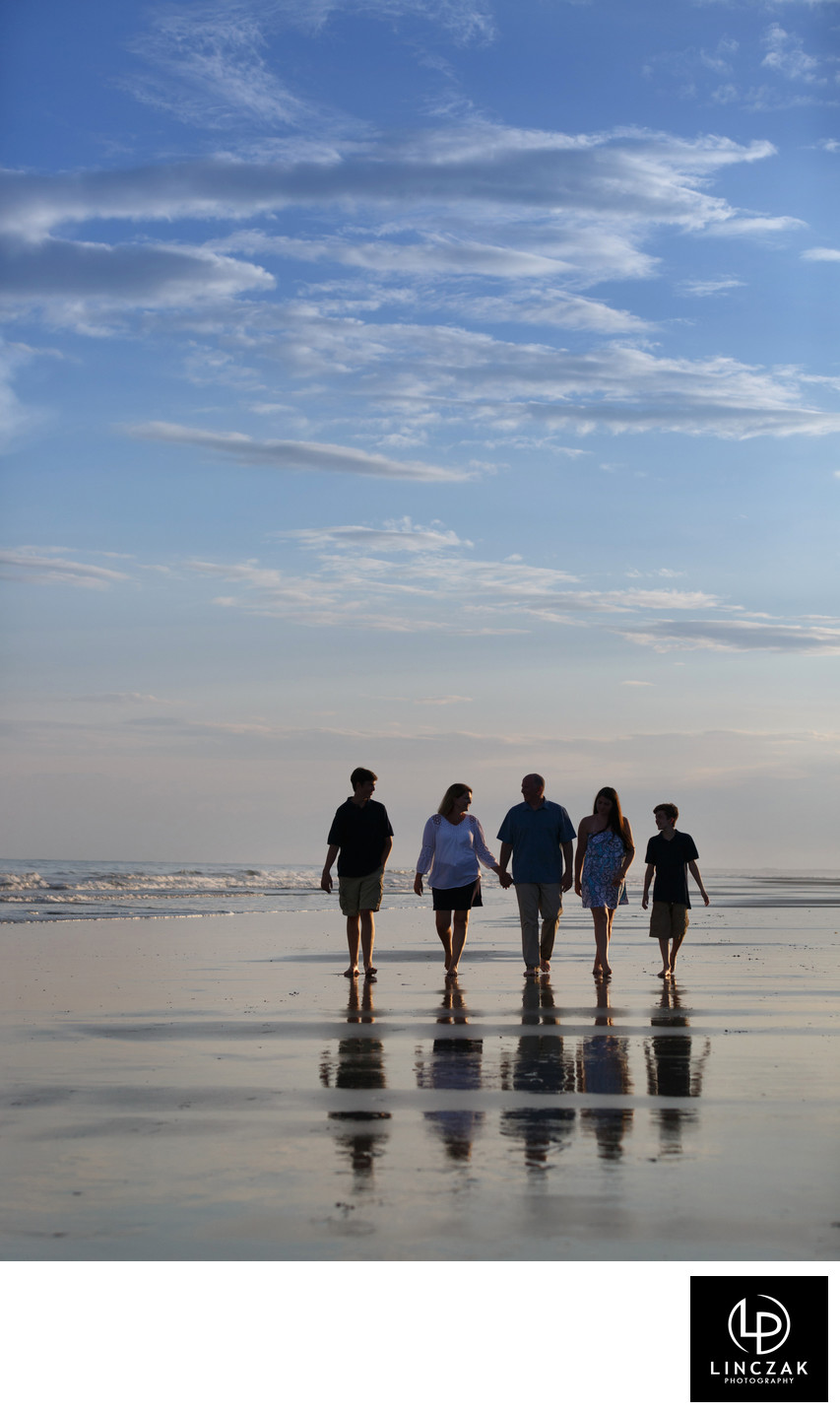 family stroll on beach photo
