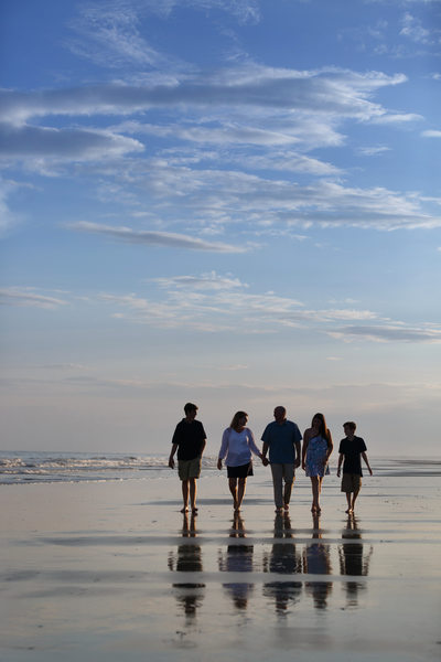 family stroll on beach photo