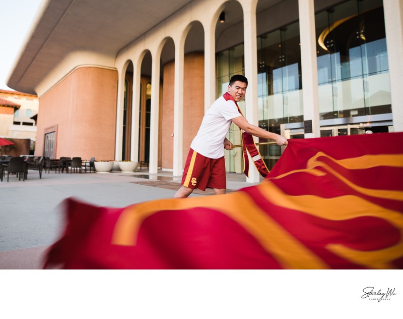 Trojan Spirit Leader Graduation Photo Waving USC Flag