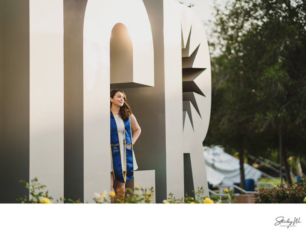 UC Riverside grad photo, sign letters, lens compression