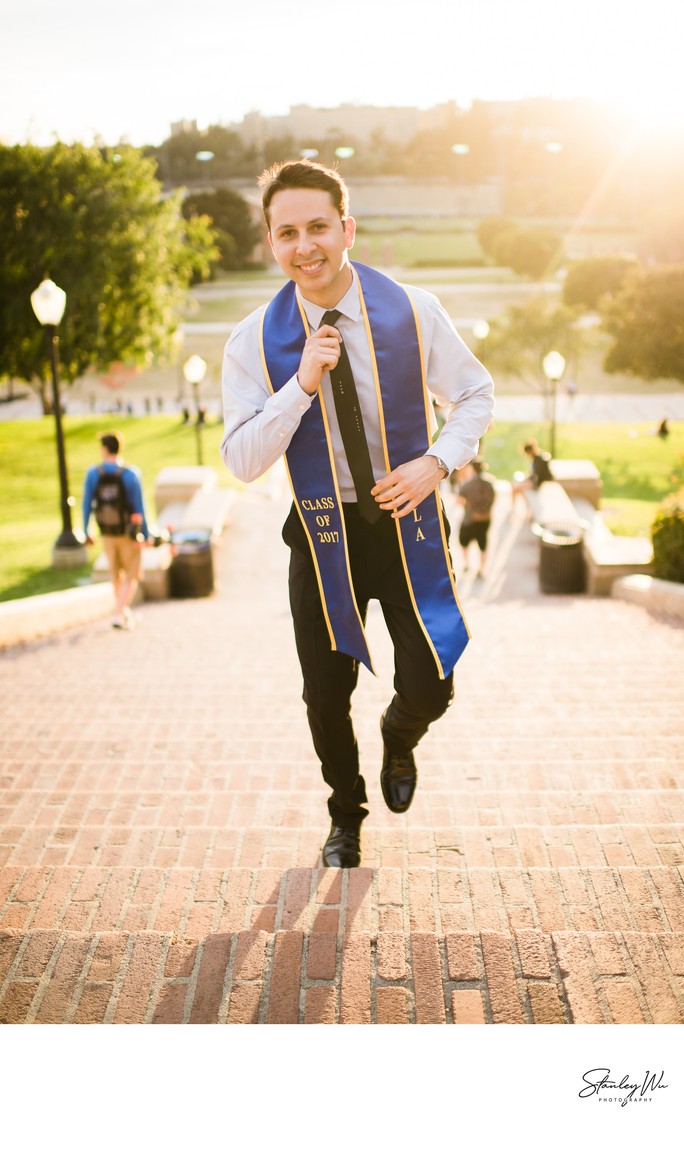 Portrait of a confident graduate walking up Janss Steps