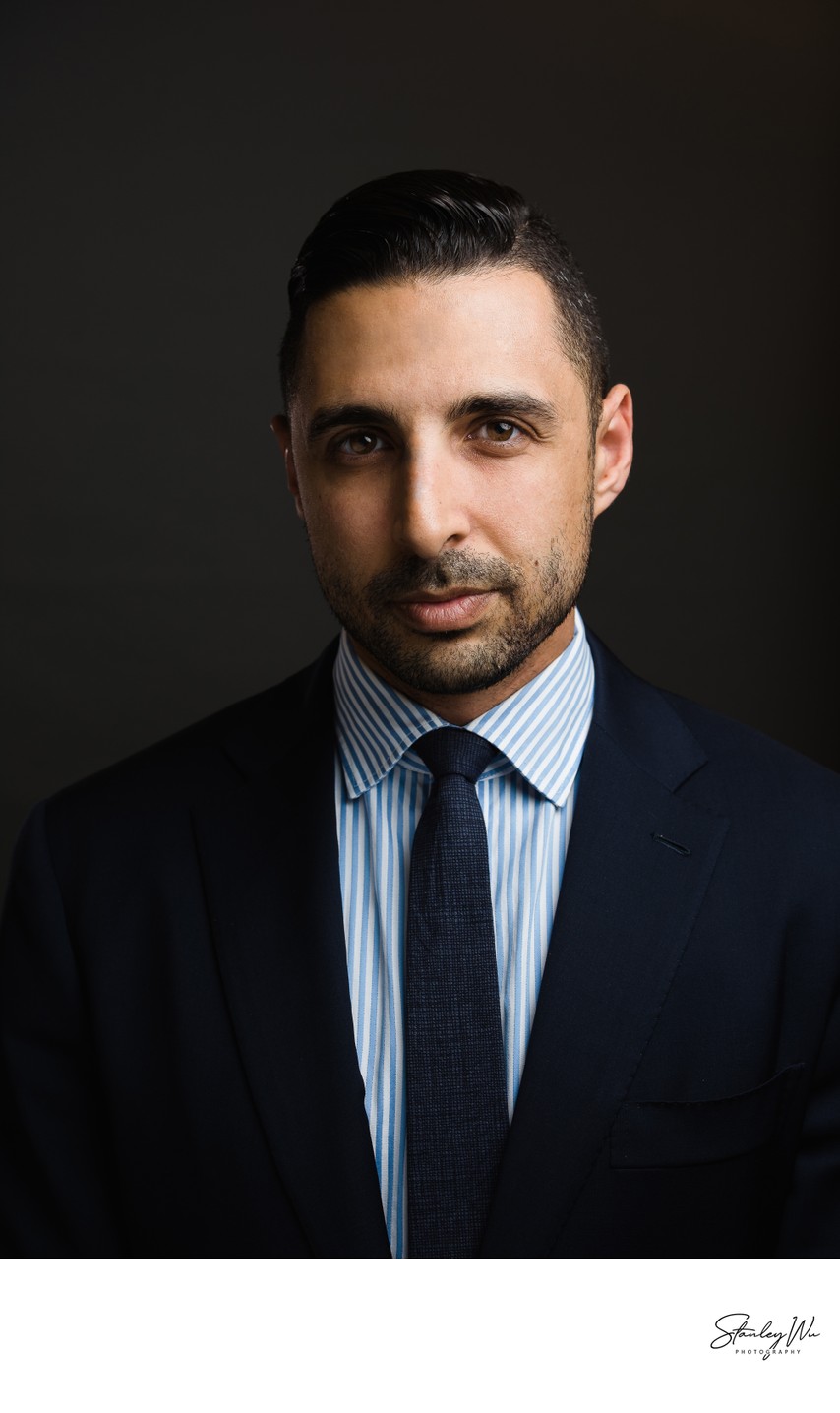 Attorney headshot, Rembrandt lighting, dark background