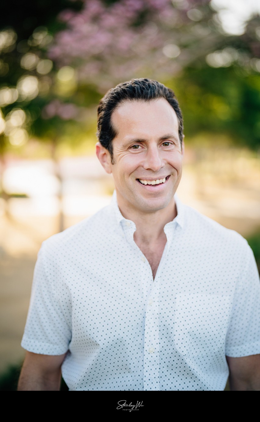 Real estate agent headshot, natural light, warm smile