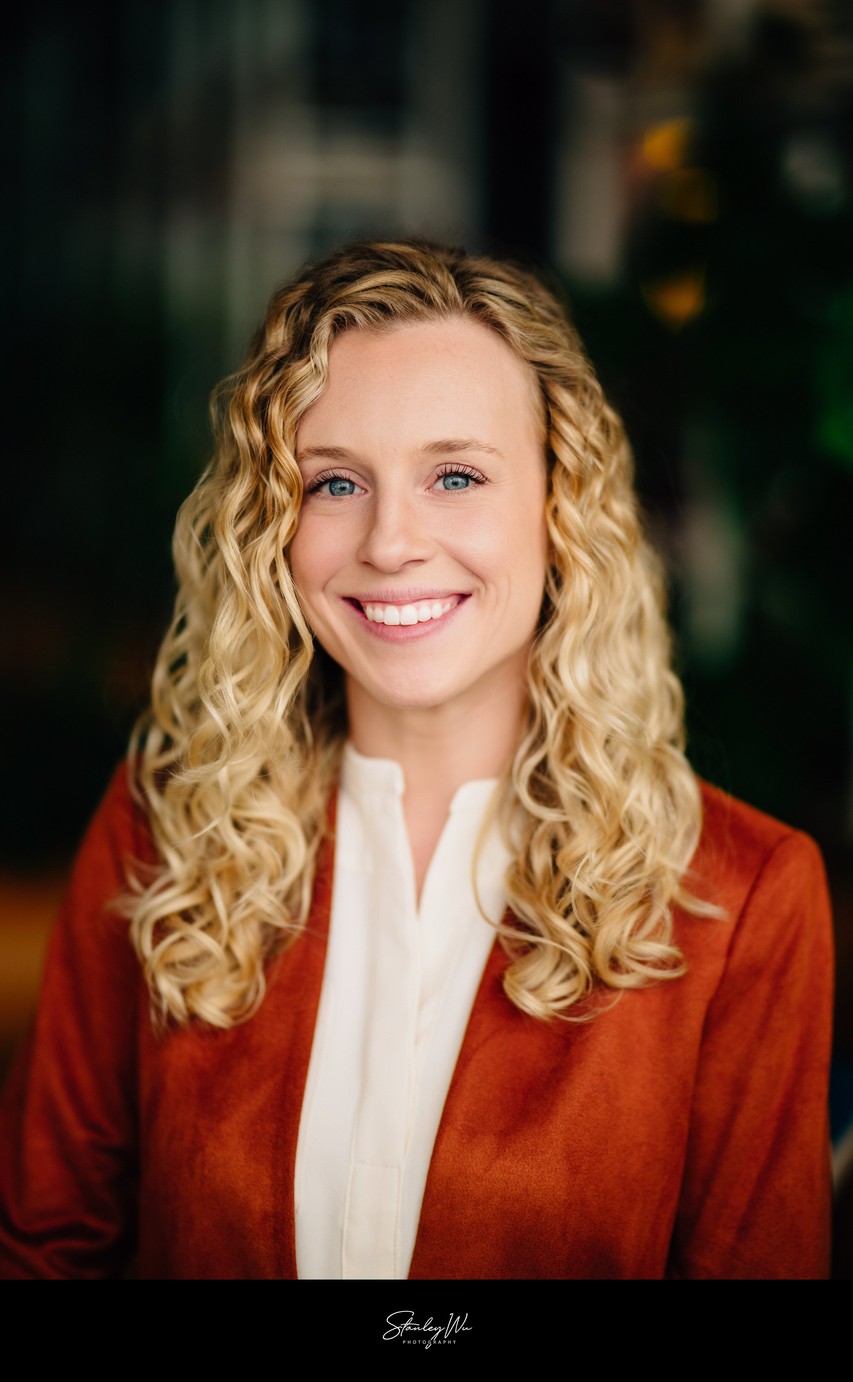 Studio headshot, natural light, warm modern outfit