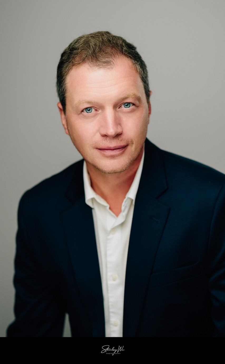 Conflict resolution coach headshot, warm studio light