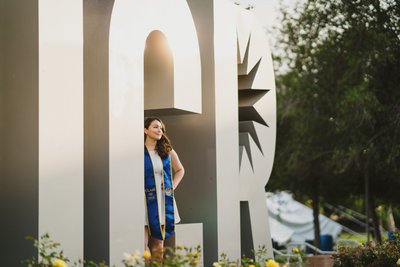 UC Riverside grad photo, sign letters, lens compression