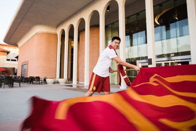 Trojan Spirit Leader Graduation Photo Waving USC Flag
