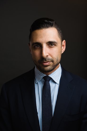 Attorney headshot, Rembrandt lighting, dark background