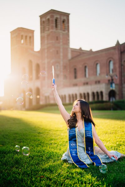 UCLA grad photo, bubbles, golden hour at Royce Hall