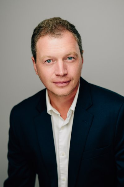 Conflict resolution coach headshot, warm studio light