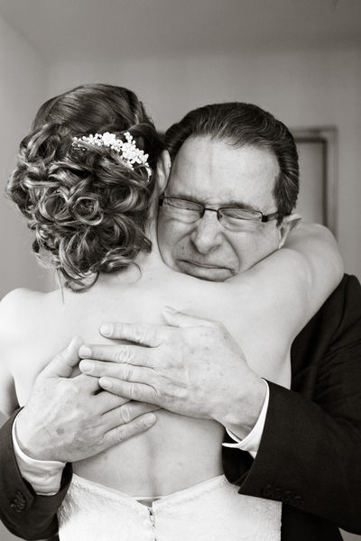 Father hugs bride Denver wedding photographer