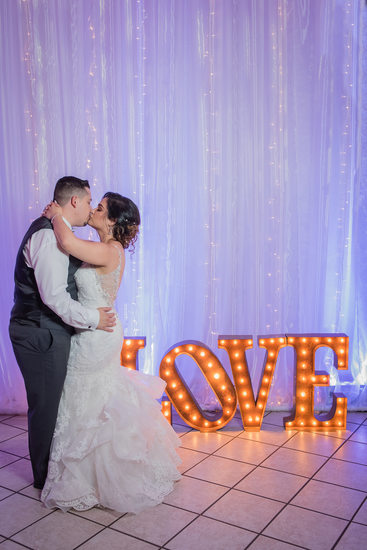 The Grove wedding reception kiss by the LOVE sign