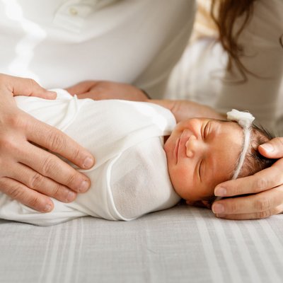 Smiling swaddled newborn baby