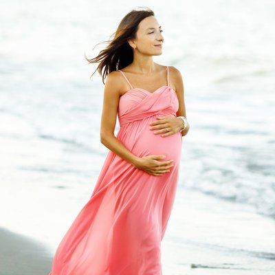 pregnant mom walking on the beach