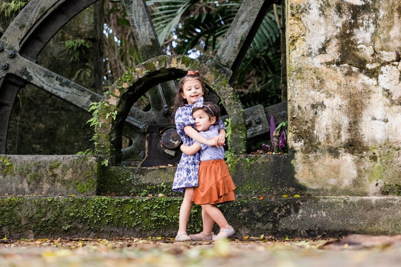 Sisters hugging Tryall Club water wheel Jamaica