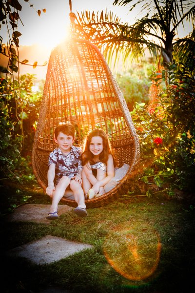 Children in hanging chair - Pimento Hill House, Jamaica