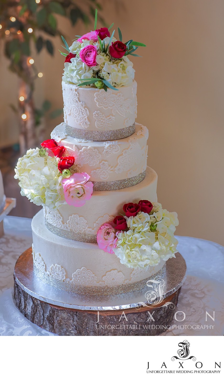 Elegant Four-Tiered Wedding Cake with Floral Accents