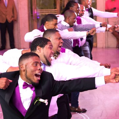 Dynamic Wedding Dance: Fraternity Brothers' Energetic Moves