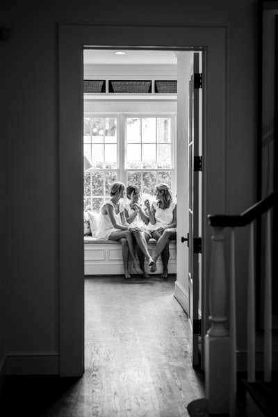 Bridesmaids talk with the bride on her wedding day