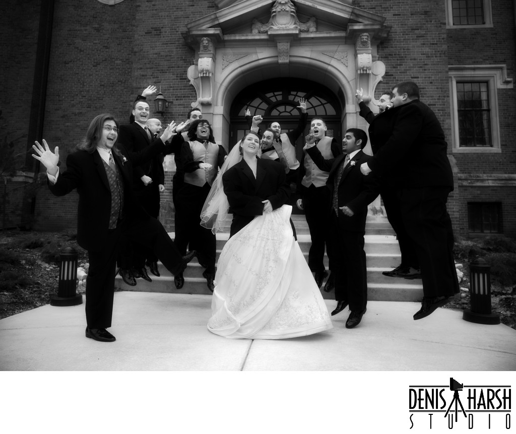 Happy Bride surrounded by Groomsmen jumping on IWU Quad