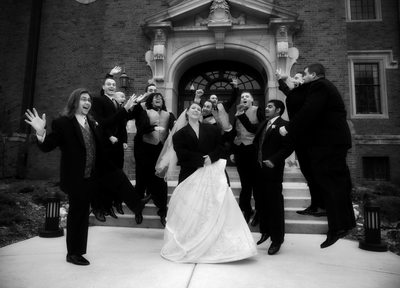 Happy Bride surrounded by Groomsmen jumping on IWU Quad