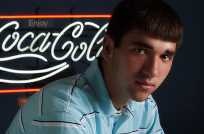 Bloomington Senior Pictures Boy with neon Coke sign