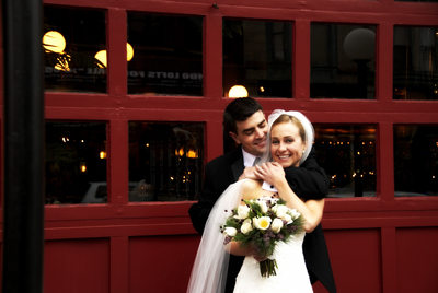 Bloomington Wedding Couple hugging in front of Red Door