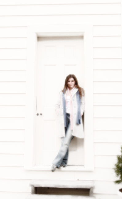 Girl Looks Striking in Soft Touch Standing in Doorway
