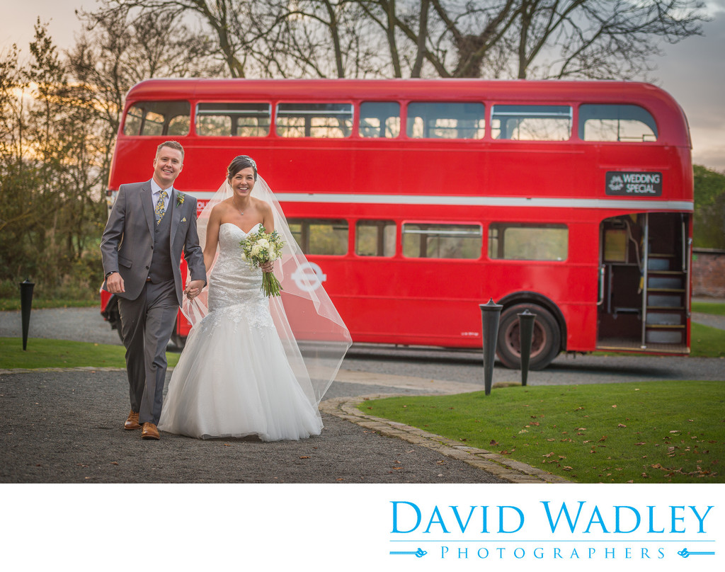 Bride & Groom photographed with London bus outside stunning Shustoke Barn.