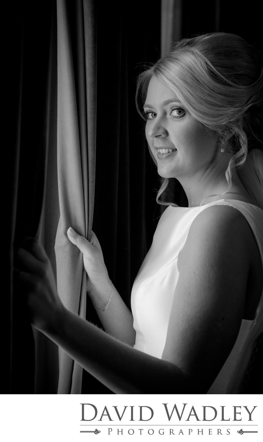 Bride looking out on her wedding day at Grafton Manor Hotel Bromsgrove.