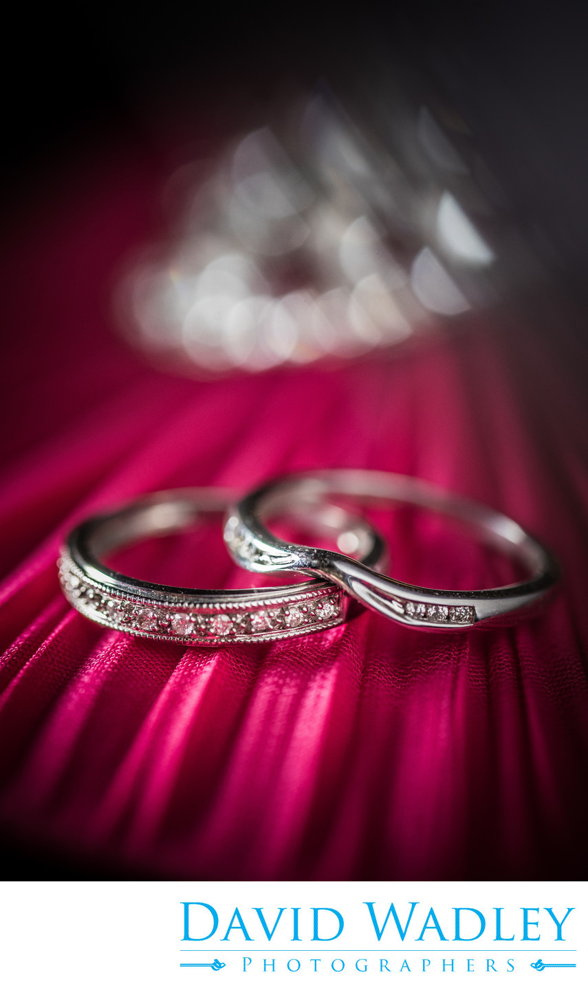 Brides wedding rings on red.