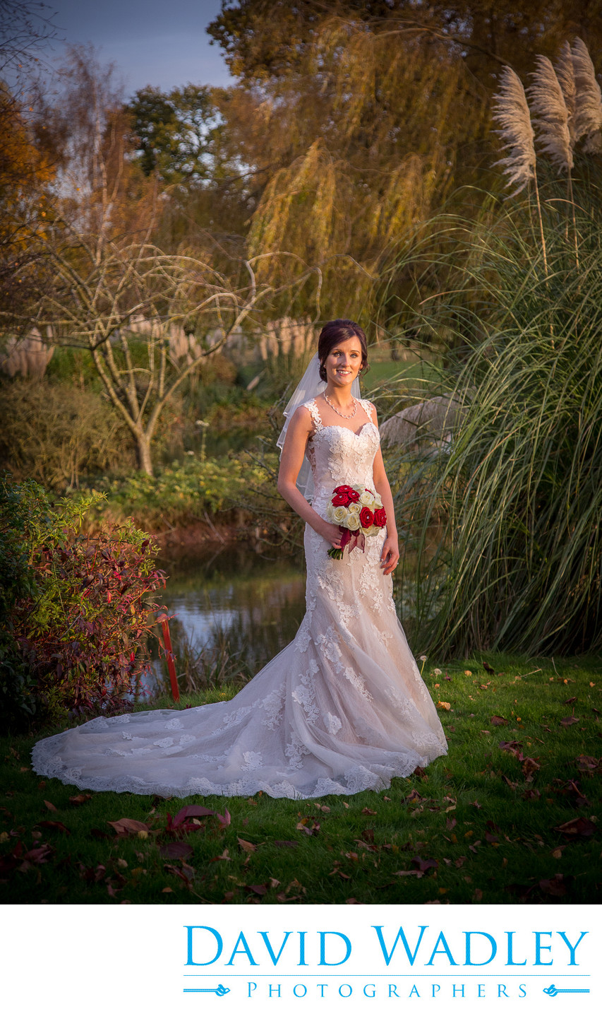 Bride next to lake at Nailcote Hall Hotel
