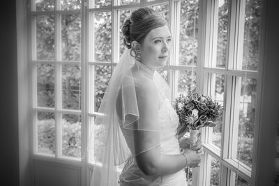 Bride looking out at Warwick House