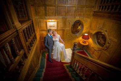 Wedding day photographed on staircase at Moor Hall Hotel.