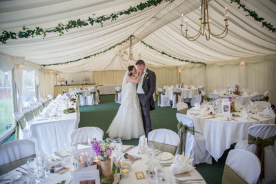Bride & Groom in marque at Grafton Manor wedding day.