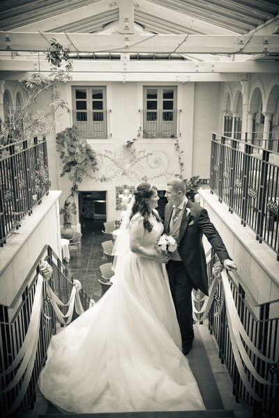 Bride & Groom at the top of the stairs at Nailcote Hall.