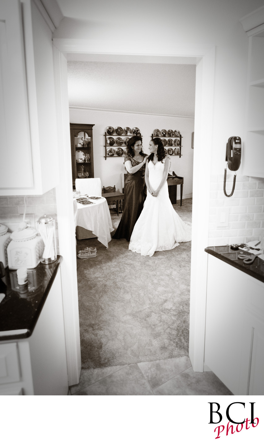 Bride and mom enjoy a tender moment before the wedding