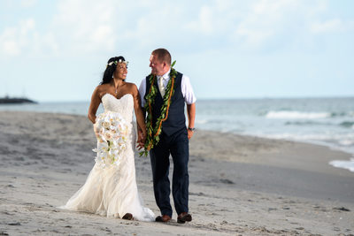 Bride and Groom stroll down the beach in Florida.