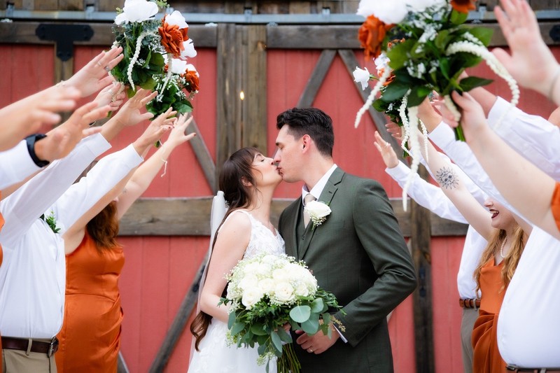 Mountain Mist Farms Newlyweds Kiss Under Arch