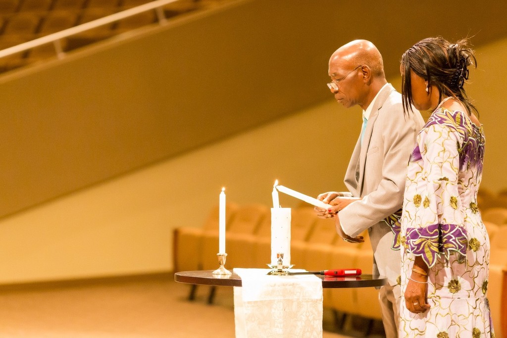 Parents Lighting Candle During Wedding