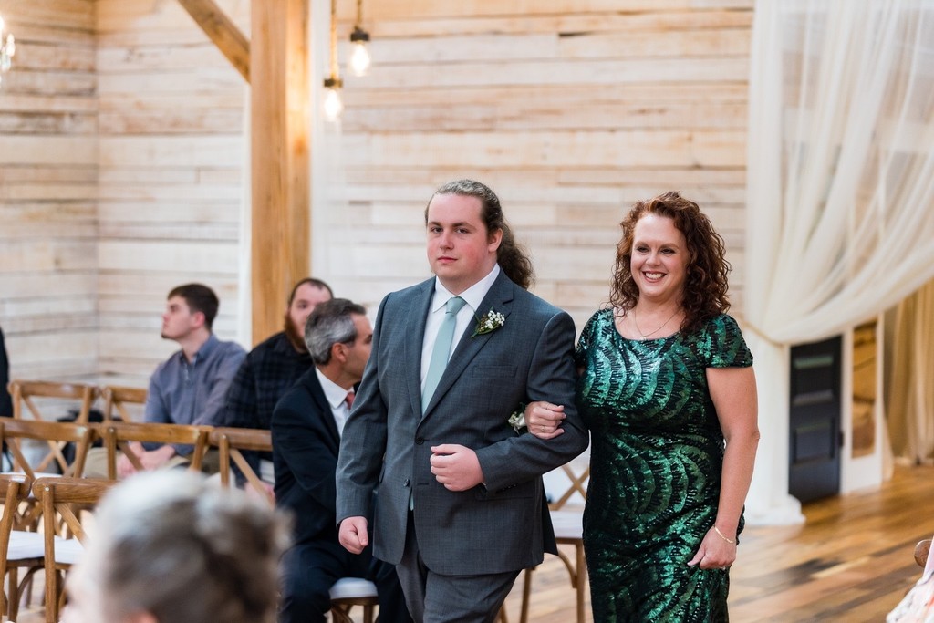 Groom's Brother Escorting Guest Down the Aisle