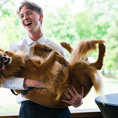 Groom Laughing with Dog at Ramble Creek