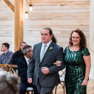 Groom's Brother Escorting Guest Down the Aisle