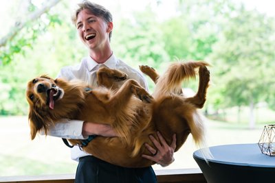 Groom Laughing with Dog at Ramble Creek