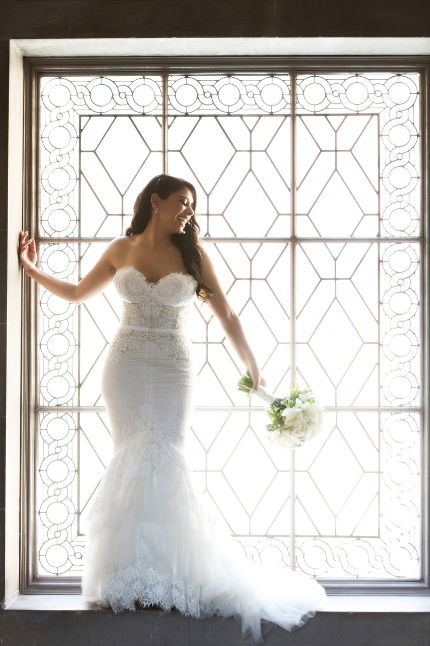 Bride standing in art deco window
