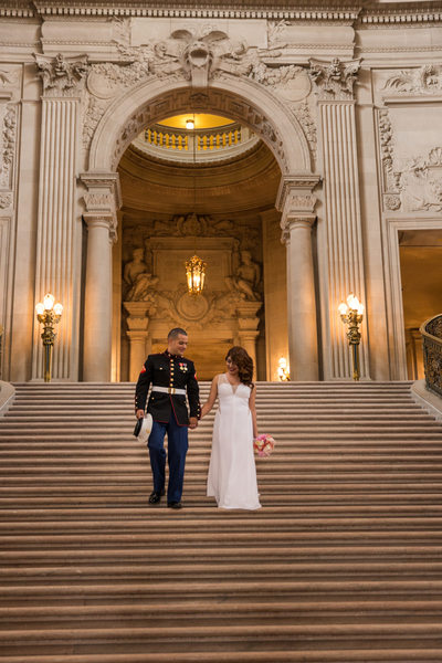 Bride and groom descend grand staircase at City Hall