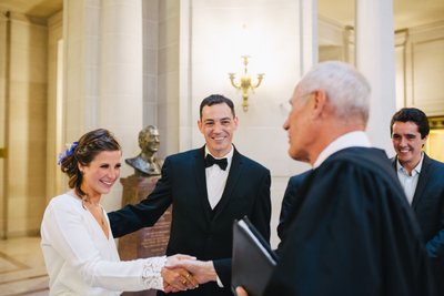 Couple and Wedding Officiant at SF City Hall