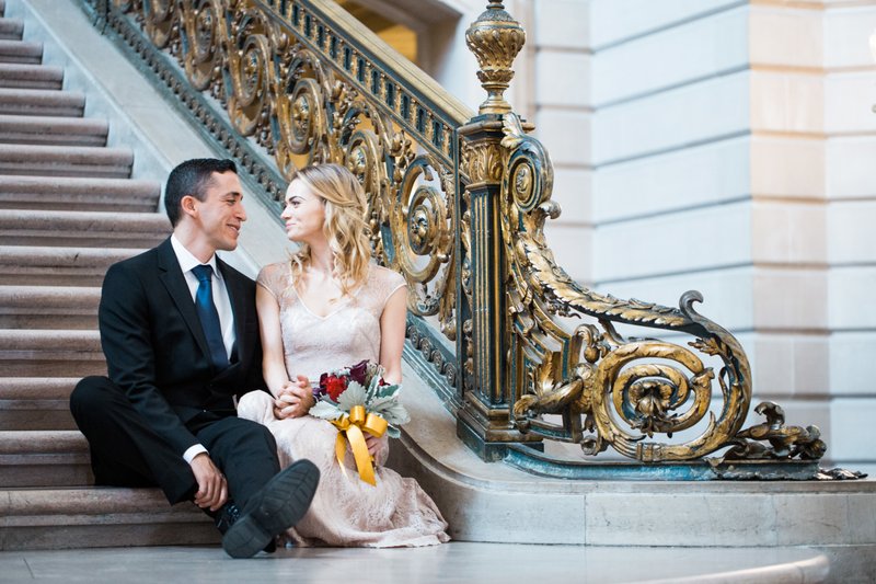Beautiful couple on the grand staircase at San Francisco City Hall