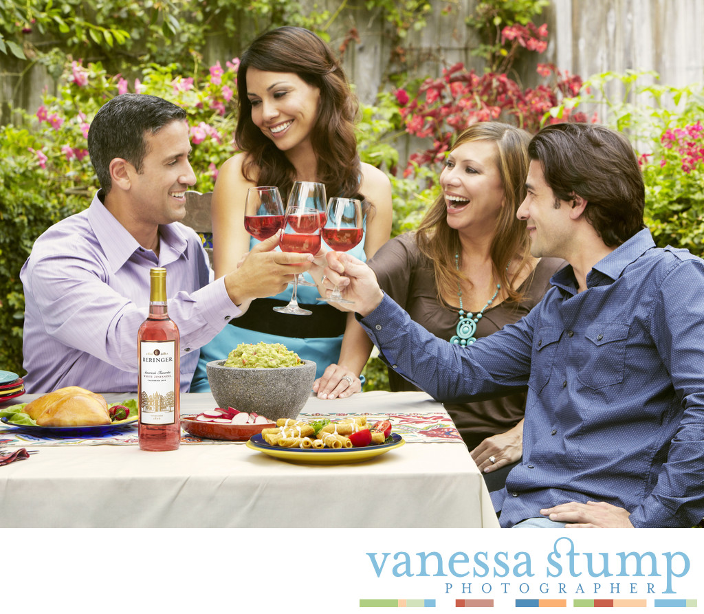 Lifestyle image of two couples enjoying wine.