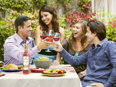 Lifestyle image of two couples enjoying wine.